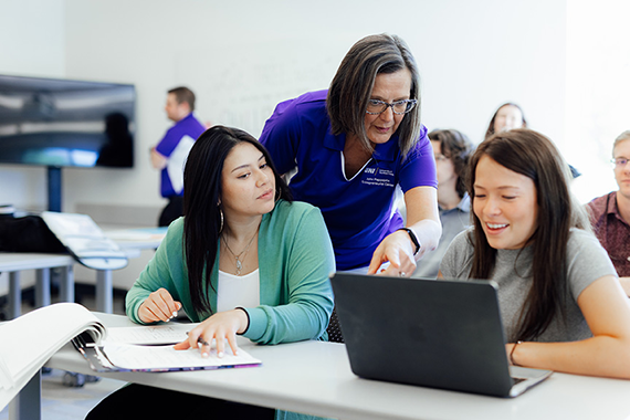 two teachers and instructor working together