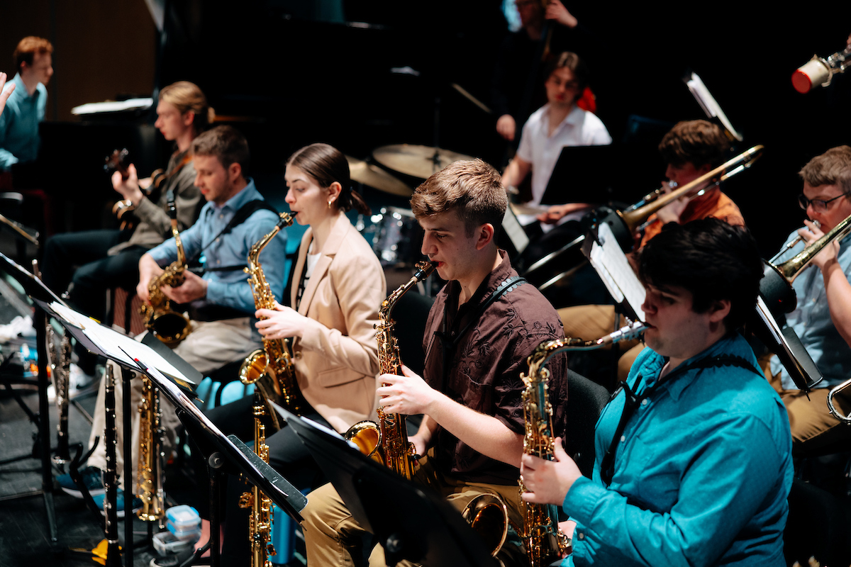 Students playing brass instruments in musical ensemble