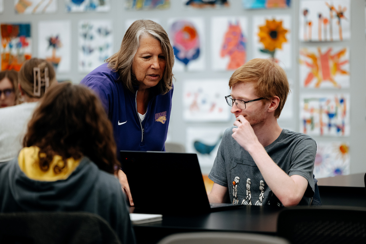 Elementary education professor helping student