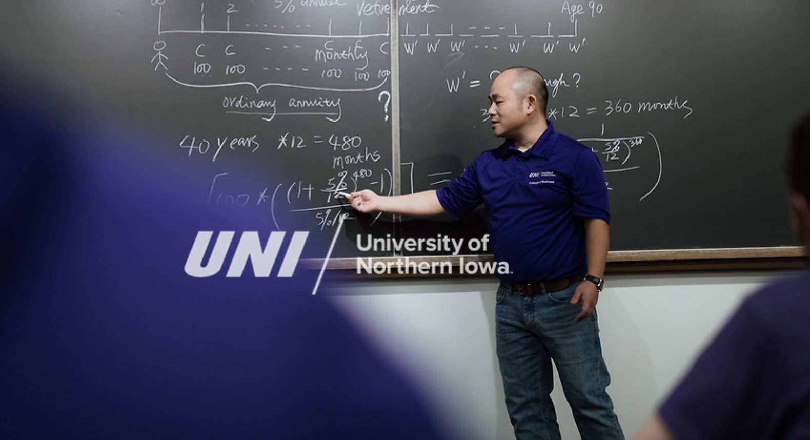 professor teaching at a chalkboard