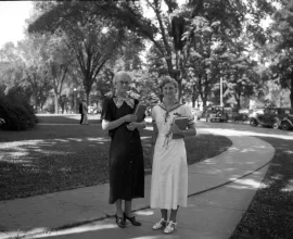 Black and white photo of students walking on UNI campus